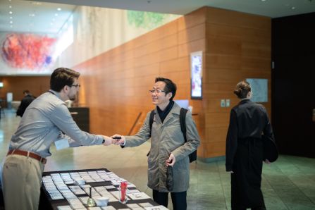 A participant chatting with the person on the registration counter