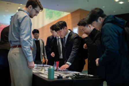 The korean delegation looking for their name tags on the registration counter
