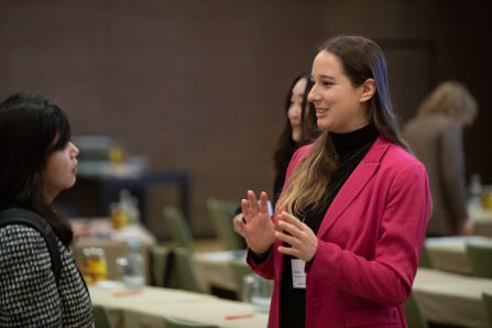 Two women chatting standing in the conference room