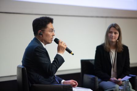 Panel: speaker speaking into mic, moderator listening