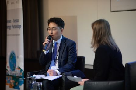 panel: speaker talking into mic, moderator listening