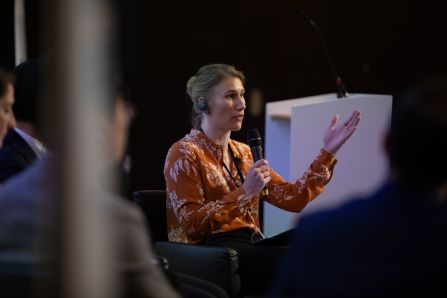 Moderator guesturing and talking to audience