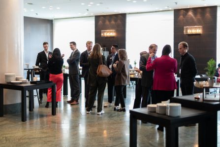 Wide shot of people chatting over coffee