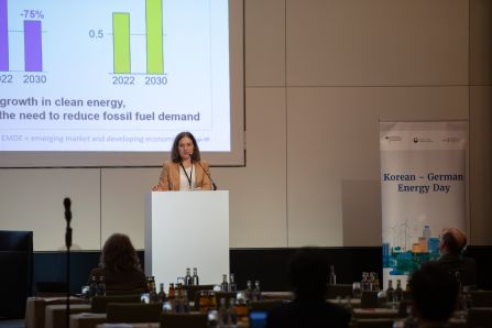 speaker infront of presentation showing a diagram
