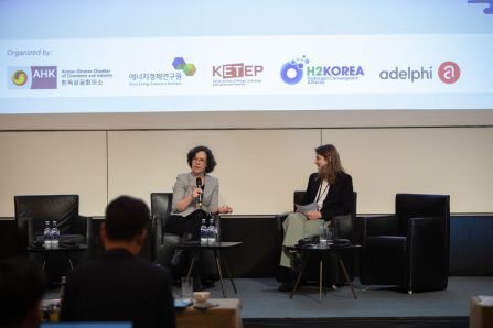 Two people speaking on panel, debriefing the day