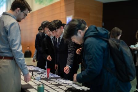 The korean delegation looking for their name tags on the registration counter